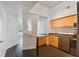 Modern kitchen with light wood cabinets, stainless steel appliances, and dark floor at 2331 W Horatio St # 610, Tampa, FL 33609