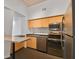 Modern kitchen with stainless steel appliances and wood cabinets at 2331 W Horatio St # 610, Tampa, FL 33609
