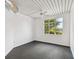 Modern bedroom with dark gray floors and a large window at 2331 W Horatio St # 610, Tampa, FL 33609