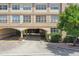 Building exterior showcasing an arched parking entrance with brick driveway and landscaping at 2331 W Horatio St # 610, Tampa, FL 33609