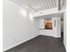 Open living area with dark gray floors and kitchen bar at 2331 W Horatio St # 610, Tampa, FL 33609