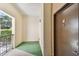 Private entrance with green flooring and modern door at 2331 W Horatio St # 610, Tampa, FL 33609