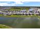 An aerial view of the neighborhood with a pond in the foreground at 10744 Hawks Landing Dr, Land O Lakes, FL 34638