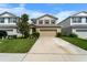 Charming two-story home with a well-manicured lawn, neutral exterior, and a spacious driveway at 10744 Hawks Landing Dr, Land O Lakes, FL 34638