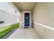 Inviting front porch features a rocking chair and a stylish blue door with a floral wreath at 10744 Hawks Landing Dr, Land O Lakes, FL 34638