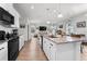 Spacious kitchen with white cabinets, granite countertops, stainless steel appliances, and an open layout at 10744 Hawks Landing Dr, Land O Lakes, FL 34638