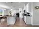 Beautiful kitchen features white cabinetry, stainless appliances, a large island, and hardwood flooring at 10744 Hawks Landing Dr, Land O Lakes, FL 34638