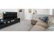 Upstairs living area with comfortable seating and a large TV at 10744 Hawks Landing Dr, Land O Lakes, FL 34638