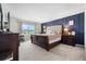 Luxurious bedroom with paneled wall, carpet and a view of the outdoors at 10744 Hawks Landing Dr, Land O Lakes, FL 34638