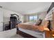 Main bedroom boasts natural light and a decorative dresser with mirror at 10744 Hawks Landing Dr, Land O Lakes, FL 34638