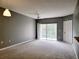 Spacious living room with gray walls, carpet, and sliding door to balcony at 6410 Cypressdale Dr # 201, Riverview, FL 33578