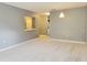 Spacious living room with gray walls, carpet, and sliding door to balcony at 6410 Cypressdale Dr # 201, Riverview, FL 33578