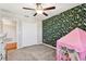 Bedroom with patterned wall, built-in dresser, and play tent at 3172 Lytton Hall Dr, Zephyrhills, FL 33540