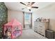Bedroom with dresser and playful tent against a feature wall at 3172 Lytton Hall Dr, Zephyrhills, FL 33540