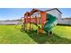 Large backyard playground with green grass at 3172 Lytton Hall Dr, Zephyrhills, FL 33540