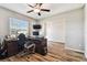 Home office with large desk, computer, and wood floors at 3172 Lytton Hall Dr, Zephyrhills, FL 33540