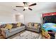 Bright Gathering room featuring two sofas and a ceiling fan at 3172 Lytton Hall Dr, Zephyrhills, FL 33540
