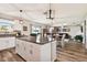 Open kitchen with island, white cabinets, granite countertops, and stainless steel appliances at 3172 Lytton Hall Dr, Zephyrhills, FL 33540
