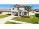 Two-story house with gray siding, gray shutters, and a landscaped front yard at 3172 Lytton Hall Dr, Zephyrhills, FL 33540