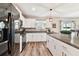 Modern kitchen with white cabinets, granite countertops, and black appliances at 3172 Lytton Hall Dr, Zephyrhills, FL 33540