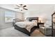 Spacious bedroom with king-size bed, ceiling fan, and ample natural light at 3172 Lytton Hall Dr, Zephyrhills, FL 33540