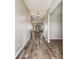 Bright hallway with wood-look flooring leading to living areas at 3172 Lytton Hall Dr, Zephyrhills, FL 33540