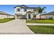 Two-story home with attached garage and landscaping at 3172 Lytton Hall Dr, Zephyrhills, FL 33540