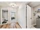 Hallway with wood-look flooring and access to bedrooms and bathroom at 3172 Lytton Hall Dr, Zephyrhills, FL 33540
