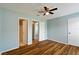 Spacious bedroom with wood flooring and access to bathroom and hallway at 9481 Highland Oak Dr # 1615, Tampa, FL 33647