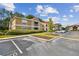 Condo building with parking lot and manicured landscaping at 9481 Highland Oak Dr # 1615, Tampa, FL 33647