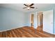 Bedroom with wood-look floors, ceiling fan, and access to two rooms at 9481 Highland Oak Dr # 1615, Tampa, FL 33647