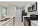 Modern kitchen with white cabinets and stainless steel appliances at 9481 Highland Oak Dr # 1615, Tampa, FL 33647