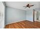 Spacious bedroom with wood-look floors and ceiling fan at 9481 Highland Oak Dr # 1615, Tampa, FL 33647