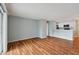 Open living room with wood-look floors and an adjacent kitchen at 9481 Highland Oak Dr # 1615, Tampa, FL 33647