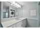 Modern bathroom with white vanity and large mirror at 9481 Highland Oak Dr # 1615, Tampa, FL 33647
