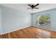 Bedroom with wood-look floors, large window and ceiling fan at 9481 Highland Oak Dr # 1615, Tampa, FL 33647