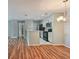 Modern kitchen with white cabinets, stainless steel appliances, and wood flooring at 9481 Highland Oak Dr # 1615, Tampa, FL 33647