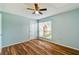 Bright bedroom featuring wood-look floors and a ceiling fan at 9481 Highland Oak Dr # 1615, Tampa, FL 33647