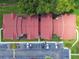Top-down view of condo building with red tile roofs and parking at 9481 Highland Oak Dr # 1615, Tampa, FL 33647
