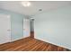 Spacious bedroom with wood-look flooring and neutral walls at 9481 Highland Oak Dr # 1615, Tampa, FL 33647