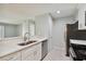 Modern kitchen with white cabinets, stainless steel appliances, and quartz countertops at 9481 Highland Oak Dr # 1615, Tampa, FL 33647
