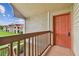Exterior condo entrance with orange door and balcony overlooking the community at 9481 Highland Oak Dr # 1615, Tampa, FL 33647
