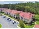 Aerial view of condo buildings with red tile roofs and parking at 9481 Highland Oak Dr # 1615, Tampa, FL 33647