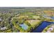 Aerial view of tennis courts near lake and community at 9481 Highland Oak Dr # 1615, Tampa, FL 33647