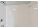 White tiled shower with built-in shelf at 9481 Highland Oak Dr # 1615, Tampa, FL 33647