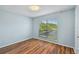 Bedroom with a large window and wood-look flooring at 9481 Highland Oak Dr # 1615, Tampa, FL 33647