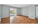 Spacious bedroom with wood-look flooring and sliding glass door to balcony at 9481 Highland Oak Dr # 1615, Tampa, FL 33647