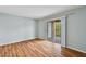 Bedroom with wood-look floors and access to a private balcony at 9481 Highland Oak Dr # 1615, Tampa, FL 33647