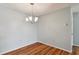 Dining room with wood flooring and a modern chandelier at 9481 Highland Oak Dr # 1615, Tampa, FL 33647