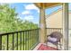 Relaxing balcony overlooking lush greenery, complete with a comfortable chair at 5134 Northridge Rd # 309, Sarasota, FL 34238